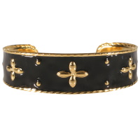 Bracelet jonc ouvert rigide en acier doré et pavé d'émail de couleur noir.