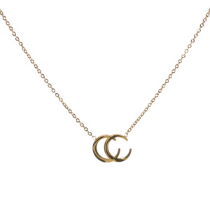 Collier composé d'une chaîne et d'un pendentif formé de deux croissants de lune superposé en acier doré. Fermoir mousqueton avec 5 cm de rallonge.