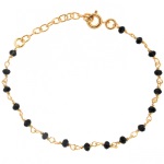 Bracelet en plaqué or jaune 18 carats composé de perles de couleur noire.