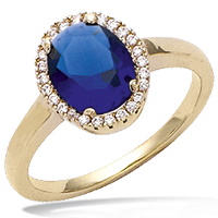 Bague solitaire en plaqué or, verre couleur saphir et oxydes de zirconium.