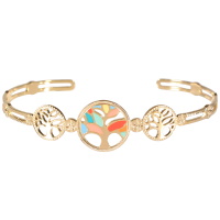 Bracelet jonc ouvert rigide avec médaillons gravés d'une étoile et trois médaillons représentant un arbre de vie en acier doré dont un pavé d'émail multicolore.