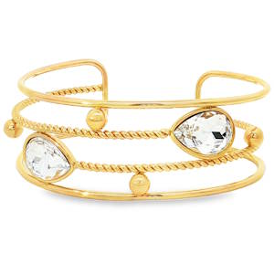 Sublime bracelet jonc en acier doré, une pièce d'éclat. Orné de cristaux taillés en poire avec une coupe brillant, ce bracelet associe luxe et modernité. Sa clarté VVS, son poli excellent et sa symétrie impeccable accentuent son allure. Un accessoire parfait pour sublimer votre style avec élégance.