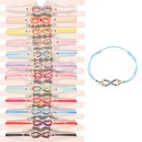 Bracelet fantaisie composé d'un cordon élastique en coton de couleur et d'un signe infini avec motifs de cœur en émail de couleur 12 coloris différents. Vendu à l'unité. Votre préférence en commentaires.