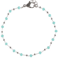 Bracelet composé d'une chaîne avec boules en acier argenté et de perles de couleur bleue turquoise. Fermoir mousqueton avec 4 cm de rallonge.