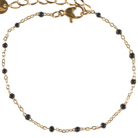 Bracelet composé d'une chaîne en acier doré et de perles en émail de couleur noir. Fermoir mousqueton avec 3 cm de rallonge.