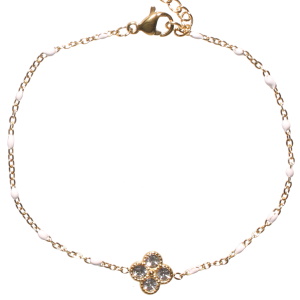 Bracelet composé d'une chaîne en acier doré, de perles en émail de couleur blanc et d'un trèfle à quatre feuilles sertis de strass. Fermoir mousqueton avec 3 cm de rallonge.