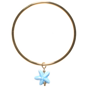 Bracelet jonc rigide fermé en acier doré avec un pendant en forme d'étoile de mer de couleur bleue.