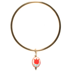 Bracelet jonc rigide fermé en acier doré avec un pendant ovale avec le dessin d'une fleur.