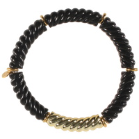 Bracelet élastique composé d'un tube tressé en acier doré et de tubes tressés en matière synthétique de couleur noire.