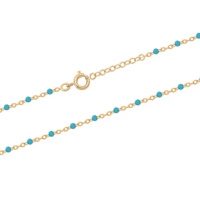Bracelet chaîne cheville composé d'une chaîne en plaqué or jaune 18 carats et de perles en résine de couleur turquoise. Fermoir anneau ressort 2 cm de rallonge.
