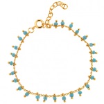 Bracelet en plaqué or et perles de couleur turquoise.