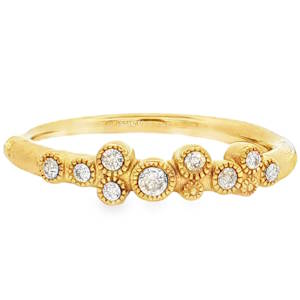 Cette bague en acier inoxydable se distingue par son anneau au fini brossé et légèrement texturé, lui donnant un aspect brut et moderne. L'élément central est une composition asymétrique de plusieurs petits cercles sertis, rappelant des bulles ou des constellations. Elle est ornée de multiples cristaux de tailles variées, qui apportent un éclat lumineux à chaque mouvement de la main.