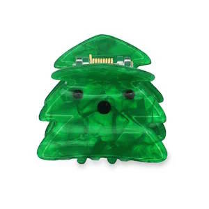 Pince à cheveux verte en forme de sapin de Noël. C'est un accessoire amusant et festif pour les fêtes de fin d'année, ajoutant une touche de gaieté à votre coiffure.