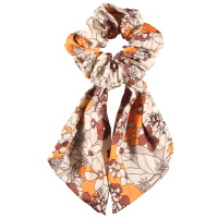 Chouchou élastique pour cheveux en forme de foulard noué en textile aux motifs de fleurs de couleur.
