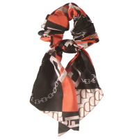Chouchou élastique pour cheveux en forme de foulard noué en textile de couleur avec motifs.