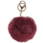 Porte-clés fantaisie boule pompon en métal doré et textile. 