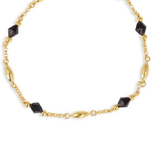 Collier composé d'une chaîne en plaqué or jaune 18 carats et de perles de cristal noir.