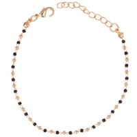 Bracelet composé d'une chaîne avec boules en plaqué or jaune 18 carats et de perles tubes de couleur noire. Fermoir mousqueton avec 3 cm de rallonge.