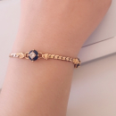 Bracelet en plaqué or avec oxydes de zirconium entourés de pierres synthétiques bleues.  Adulte Femme Indémodable 